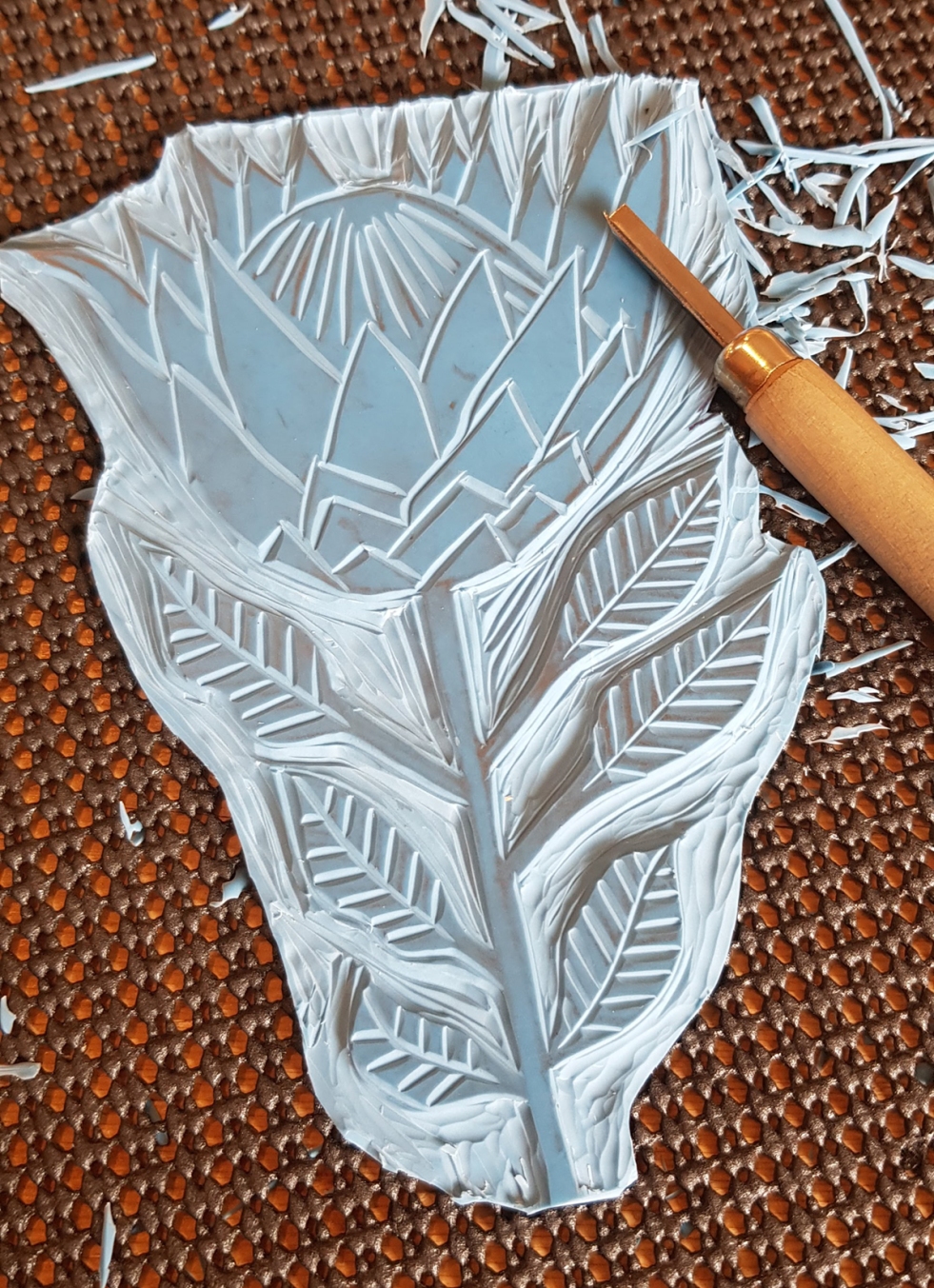 Lino printing block with a protea flower